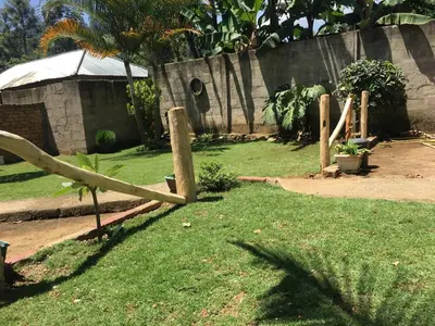 a wooden fence in a yard with green grass at Humphrey home stay in Arusha