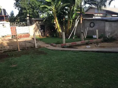 a yard with a fence and a house at Humphrey home stay in Arusha