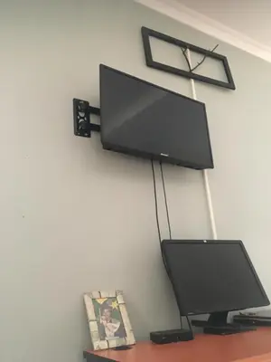 a flat screen tv hanging on a wall at Humphrey home stay in Arusha