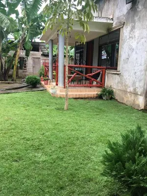 a porch of a house with a green yard at Humphrey home stay in Arusha