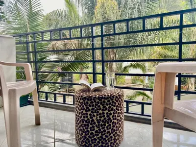a room with a table and a book and a chair at Our Home your Home in Arusha in Nkoanrua