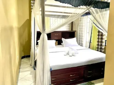 a bedroom with a canopy bed with teddy bears on it at Our Home your Home in Arusha in Nkoanrua