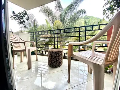 a balcony with two chairs and a table at Our Home your Home in Arusha in Nkoanrua