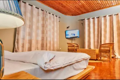 a bedroom with a bed and a television in it at Asante Home in Arusha