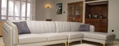 a white couch sitting in a living room at Asante Home in Arusha