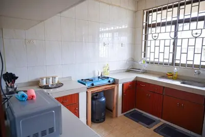 a small kitchen with a sink and a stove at Arusha Urban Haven Homes - Amani Apartment in Arusha