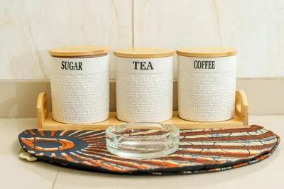 a wooden tray with four tea cups and aucer at Arusha Urban Haven Homes - Amani Apartment in Arusha