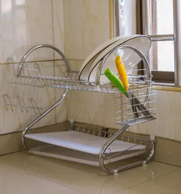 a metal rack with a ruler and a pen at Arusha Urban Haven Homes - Amani Apartment in Arusha