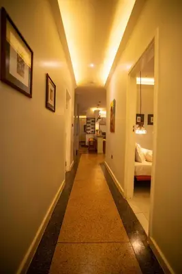 a hallway with a room with a bed and a hallwayngthngthngthngthngth at The Green House in Arusha