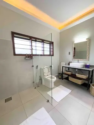 a bathroom with a shower and a toilet and a sink at The Green House in Arusha
