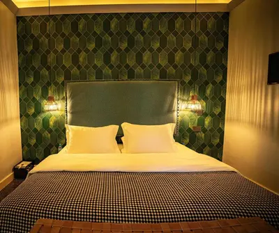 a bedroom with a large bed with two pillows at The Green House in Arusha
