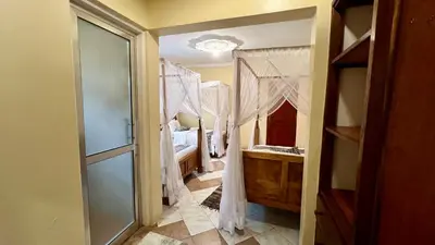 a bathroom with a shower and a sink in a room at Ultra Home Hostel in Arusha