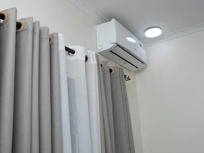 a room with curtains and a security camera at damanda homes in Moshi