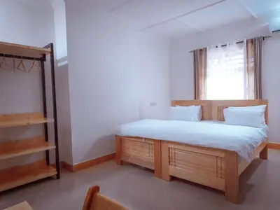 a bedroom with a large bed and a window at damanda homes in Moshi