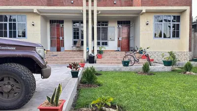 a truck parked in front of a house at kijiji Nest in Usa River