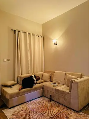 a person laying on a couch in a living room at kijiji Nest in Usa River