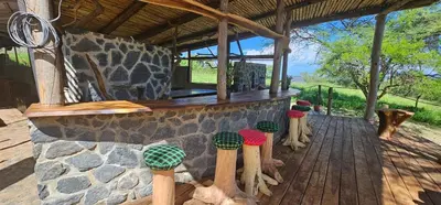 a group of wooden baseball bats on a porch at Shamba Pori Lodge in Idulo