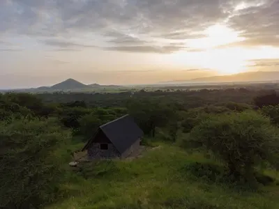 a small cabin in the middle of a field at Shamba Pori Lodge in Idulo