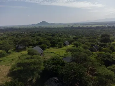 an aerial view of a farm with trees and buildings at Shamba Pori Lodge in Idulo