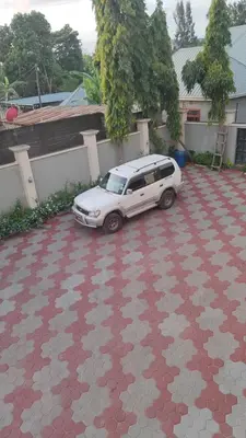 a white car parked on a red and white tile floor at \u86cb\u7092\u996d\u6c11\u5bbf in Samanga