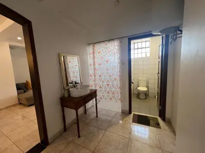 a bathroom with a sink and a toilet at Cosy 2 bedroom apartment in Arusha