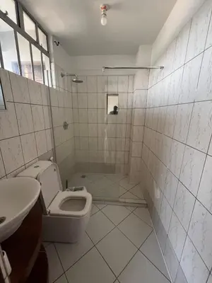 a bathroom with a toilet and a sink at Cosy 2 bedroom apartment in Arusha