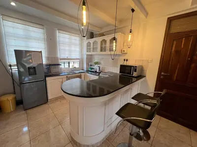 a kitchen with a large island in the middle at Cosy 2 bedroom apartment in Arusha