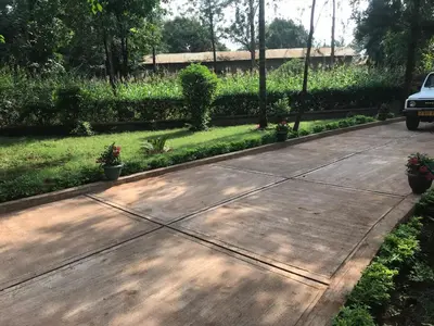 a driveway with a car parked in a yard at Kitonga Escape in Msaranga