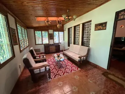 a living room with a couch and chairs and a table at Kitonga Escape in Msaranga