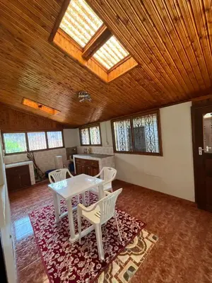a room with a table and chairs on a rug at Kitonga Escape in Msaranga