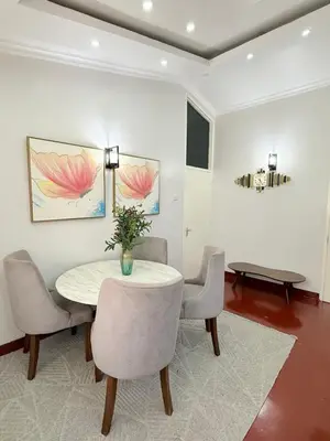 a dining room with a table and chairs at Aggiestays - Shanty Town Moshi in Moshi