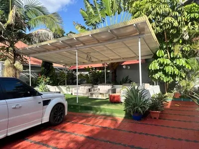 a white car parked under a pergola at Dema home in Arusha
