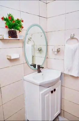 a bathroom with a sink and a mirror at Dema home in Arusha