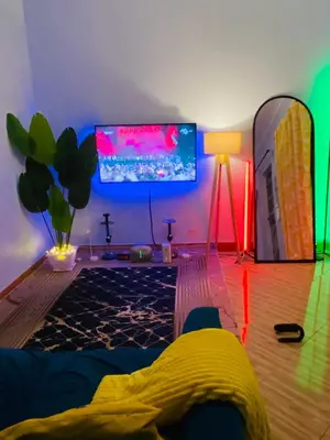 a living room with a tv and a table with a lamp at gustavo in Sokon