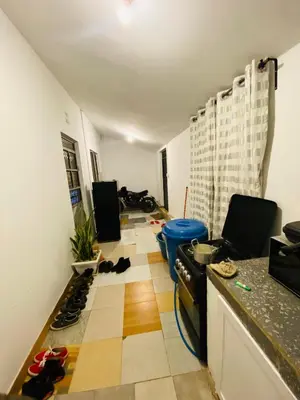 a kitchen with a floor with shoes on the floor at gustavo in Sokon