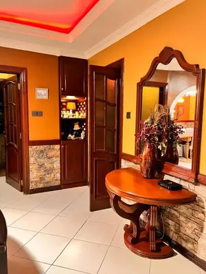 a dining room with a table and a mirror at Meru Havens in Arusha