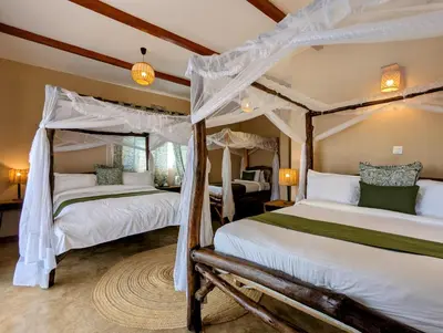 two twin beds in a room with a bedroom at Mvuli Mountain Lodge Ngorongoro in Karatu