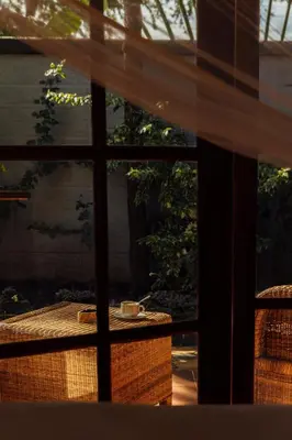 a window view of a table with a cup on it at Shoki Shoki Lodge Arusha in Arusha