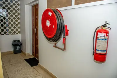 a fire hydrant hanging on the side of a wall at Newdol homestay Arusha Tanzania in Arusha