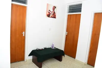 a room with two doors and a table in front of it at Newdol homestay Arusha Tanzania in Arusha