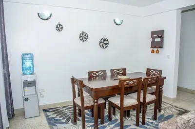 a dining room with a table and chairs at Newdol homestay Arusha Tanzania in Arusha