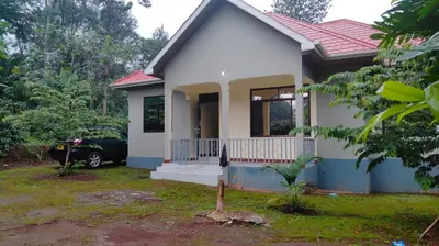 a house with a car parked in front of it at Shio homestay in Uru