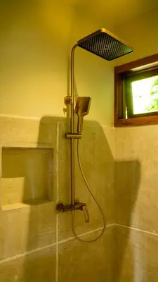 a shower in a bathroom with a lamp in a room at Mateves boutique lodge in Arusha