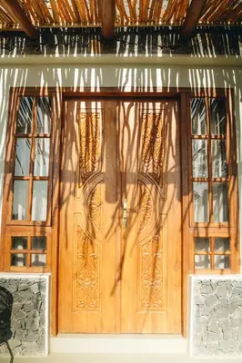 a pair of wooden doors on a house at Mateves boutique lodge in Arusha