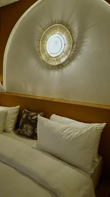 a bedroom with a bed with a clock on the ceiling at Mateves boutique lodge in Arusha