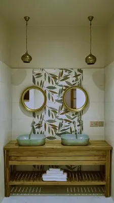 a bathroom with two sinks and two mirrors at Mateves boutique lodge in Arusha