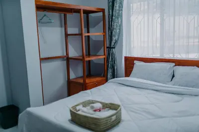 a bedroom with a bed with a basket on it at St Benedict House in Moshi