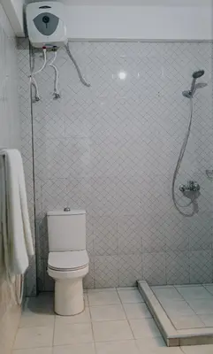 a bathroom with a toilet and a shower at St Benedict House in Moshi