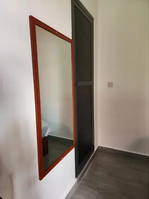 a bathroom with a mirror and a toilet in a room at Mimi Home in Arusha