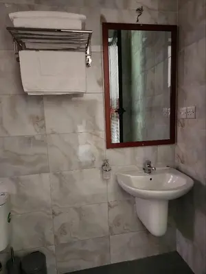 a bathroom with a sink and a mirror at Mimi Home in Arusha